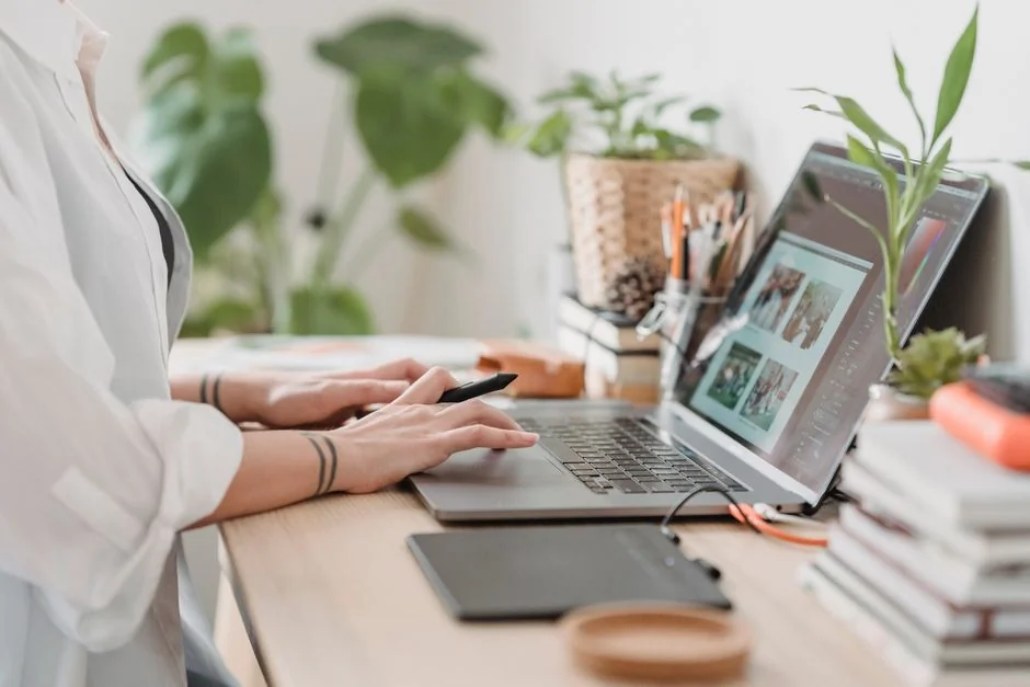 Stylish and efficient workspace with multiple monitors, laptop, and smartphone, showcasing a web design project.